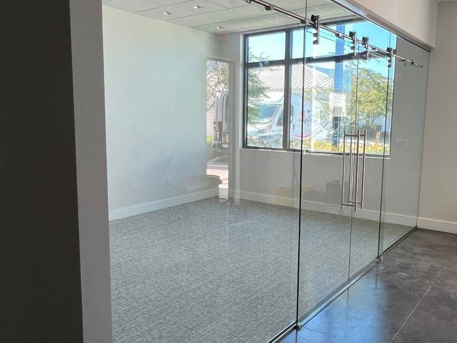 Interior glass wall with sliding doors to a ground-floor space