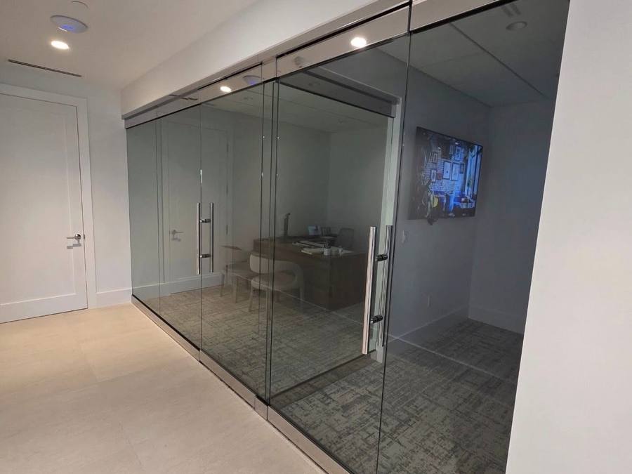 Mirror-finish glass office front with polished stainless frame